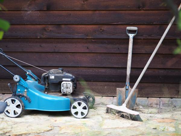 Lawn mower in front of a wooden wall—how to keep mice out of lawn mower