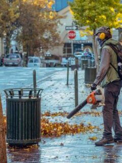 A man holding a leaf blower—electric leaf blower and gas leaf blower