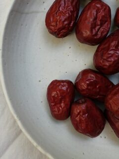 dried red berries on a white plate—how to grow jujube from seed