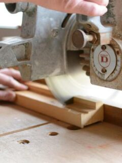 A person cutting wood with a miter saw—can a 10 inch miter saw cut a 4x4 1