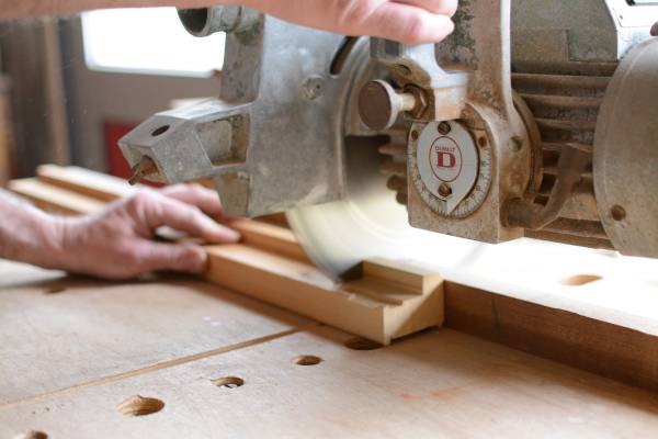 A person cutting wood with a miter saw—can a 10 inch miter saw cut a 4x4 1