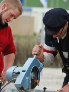Two men working—can you cut PVC with a miter saw
