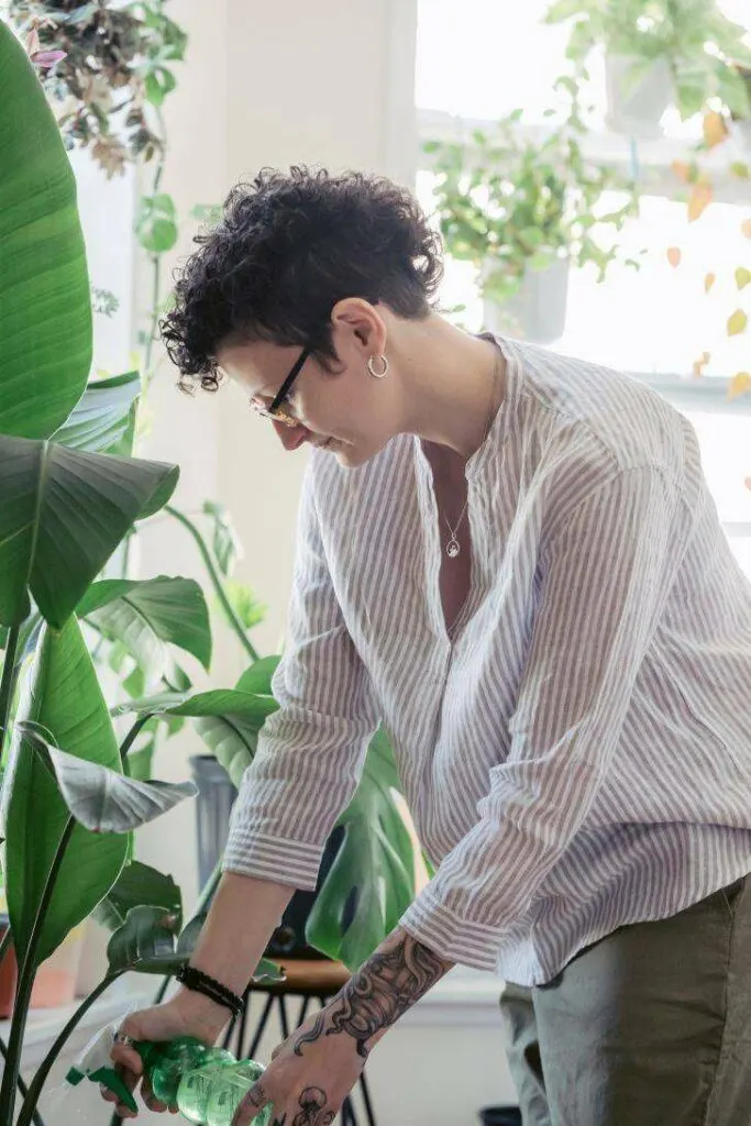 A Woman Wearing Breathable Fabric While Gardening at Home