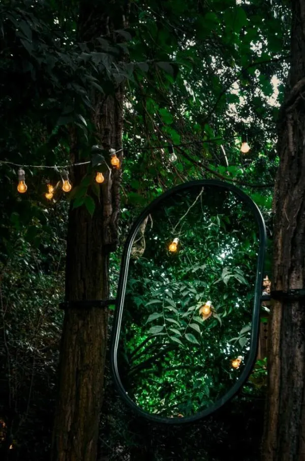 A beautiful mirror reflecting lanterns hanging in a garden 678x1024 1