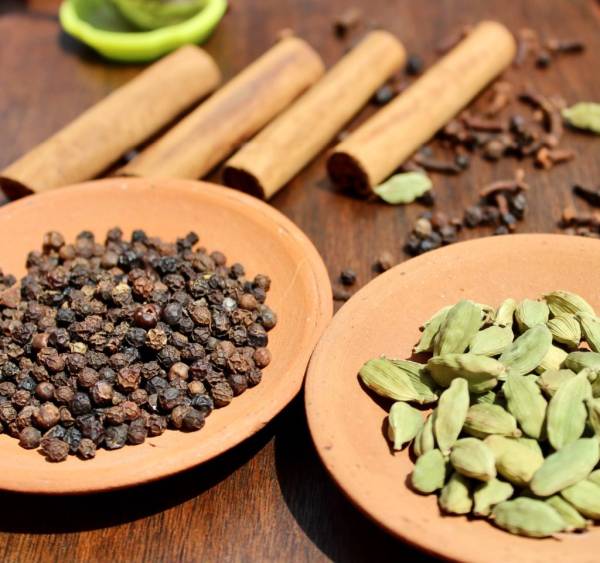 Spices in plates on the table—why is cardamom so expensive